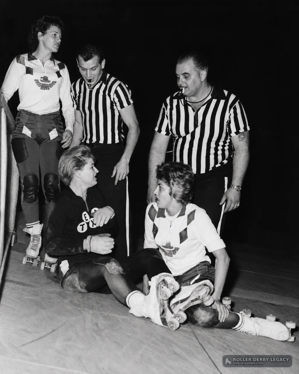 Skaters and Referees Gather on Indoor Roller Derby Track