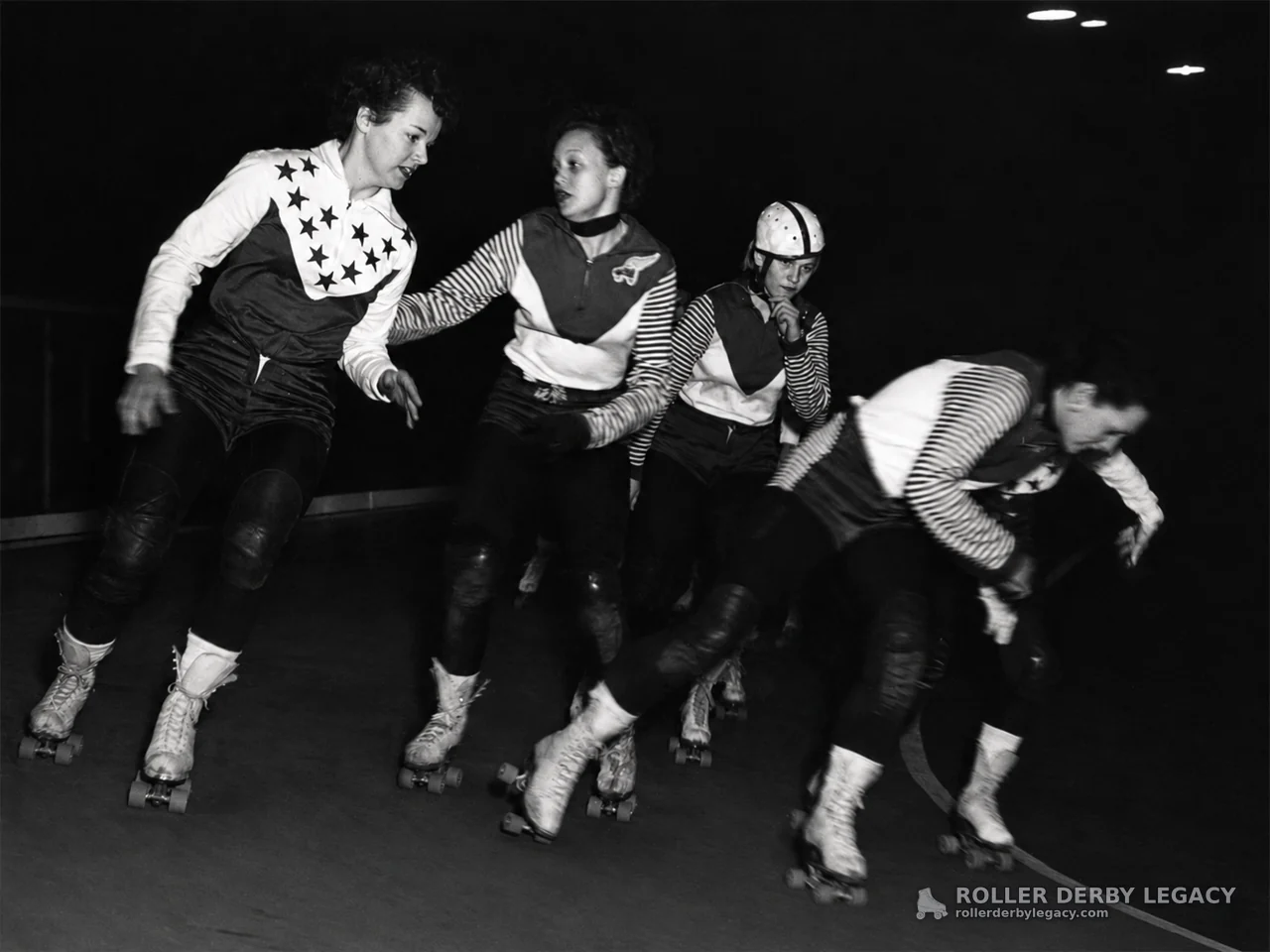 Four Skaters on an Indoor Roller Derby Track