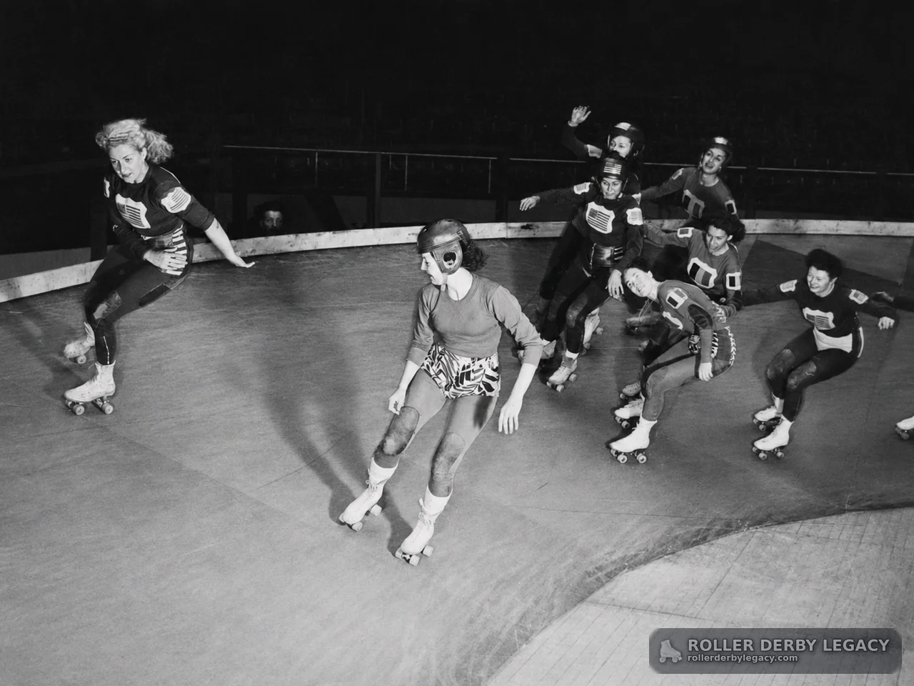 Roller Derby Skaters Rounding an Indoor Track