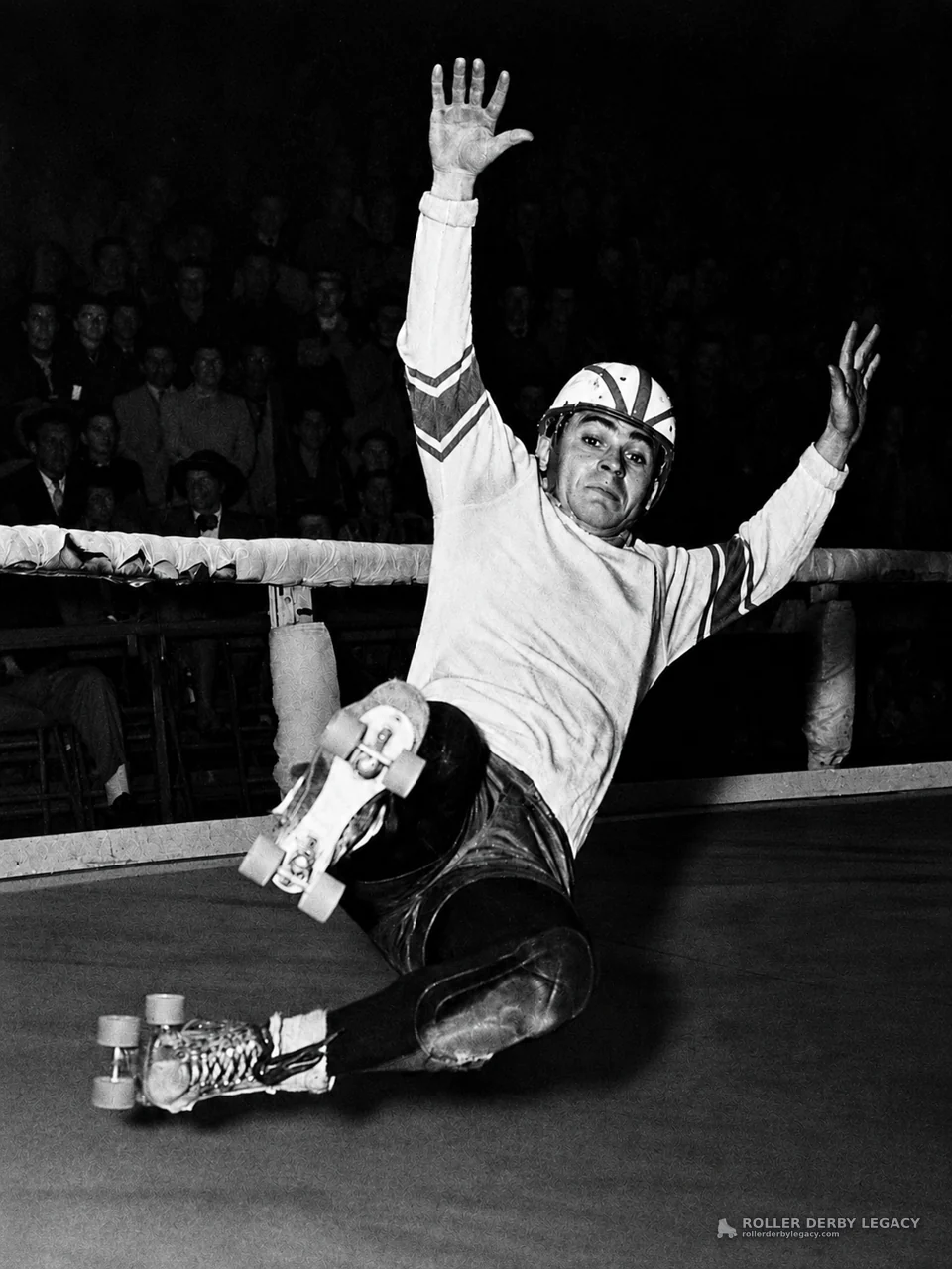 Helmeted Roller Skater Sliding on an Indoor Track