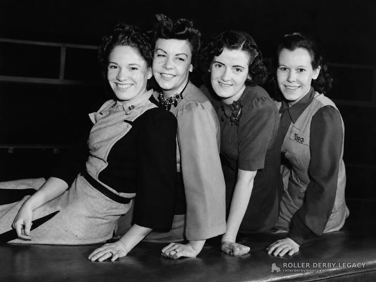Four Women Posing in a Black-and-White Group Portrait