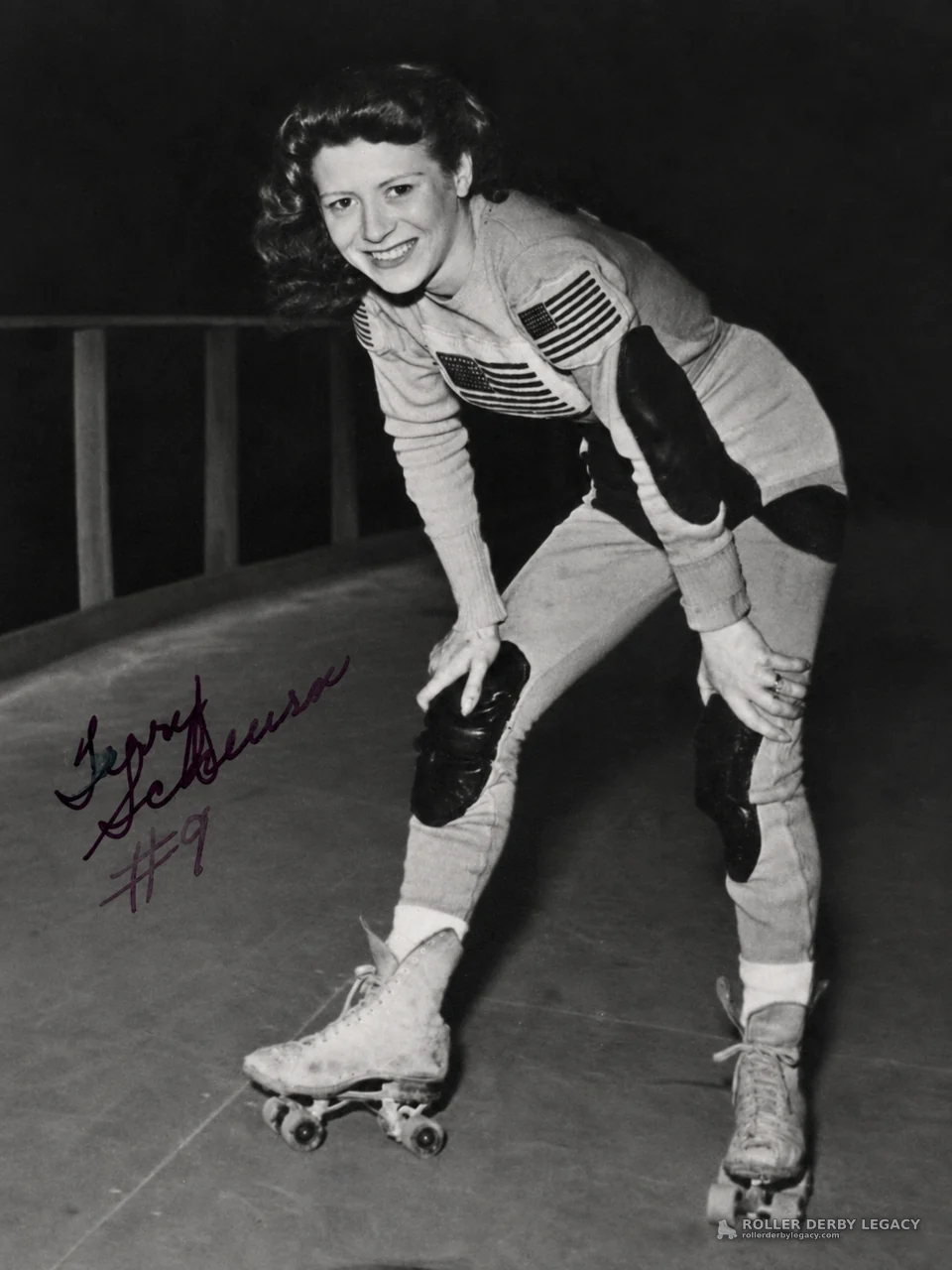 Smiling skater inscribed “Gerry #9” at indoor rink
