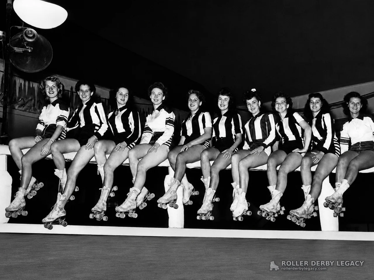 Women Skaters in Striped Uniforms at an Indoor Rink