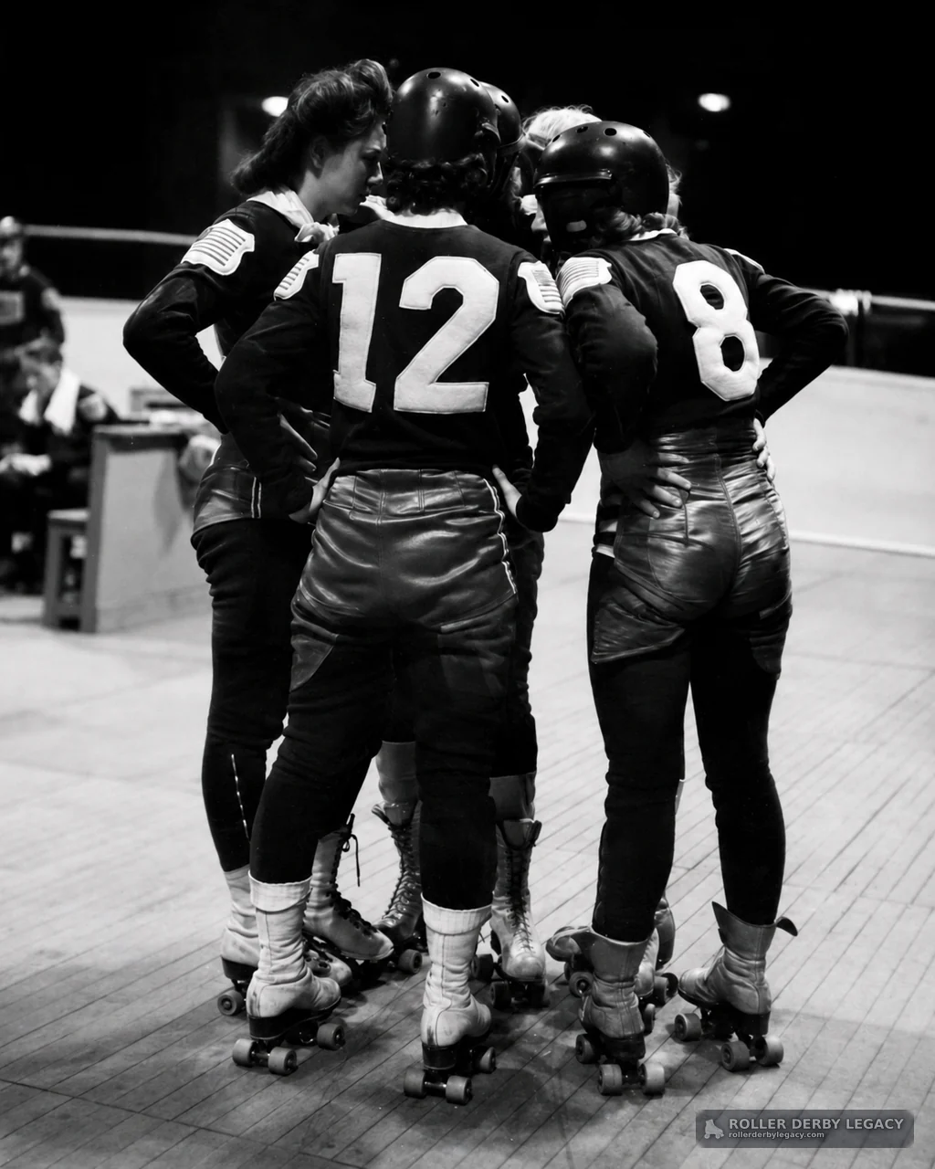 Roller Derby Skaters Huddle on Indoor Rink