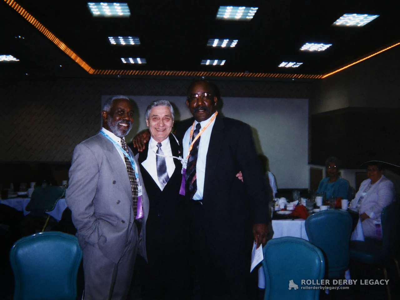 Three Suited Men in a Banquet Room
