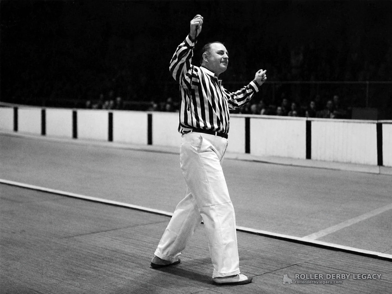 Striped-Shirt Official Signals on Indoor Track