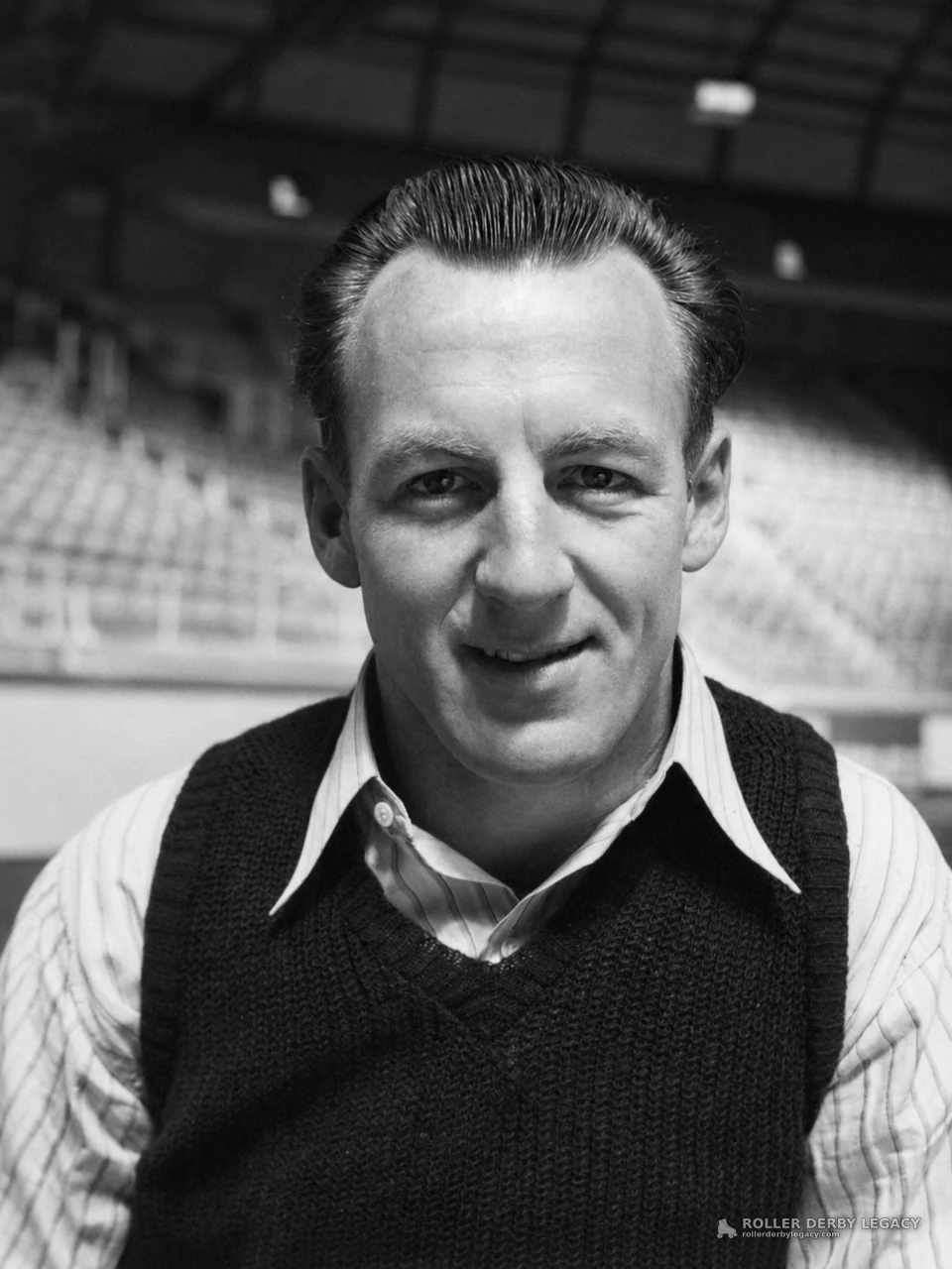 Man in Sweater Vest at an Indoor Arena