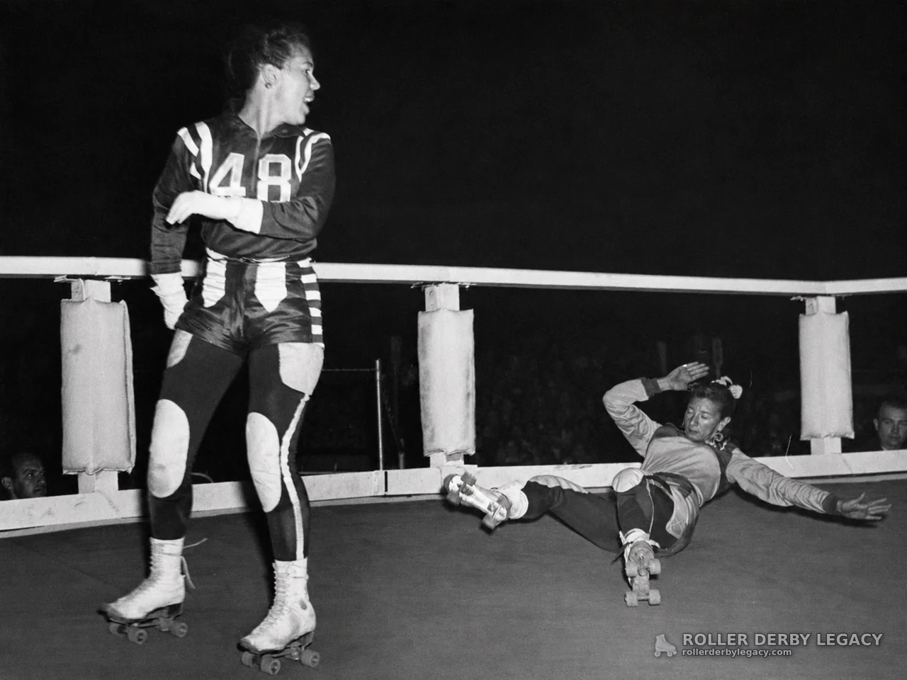 Roller Derby Skater 48 Beside a Fallen Skater