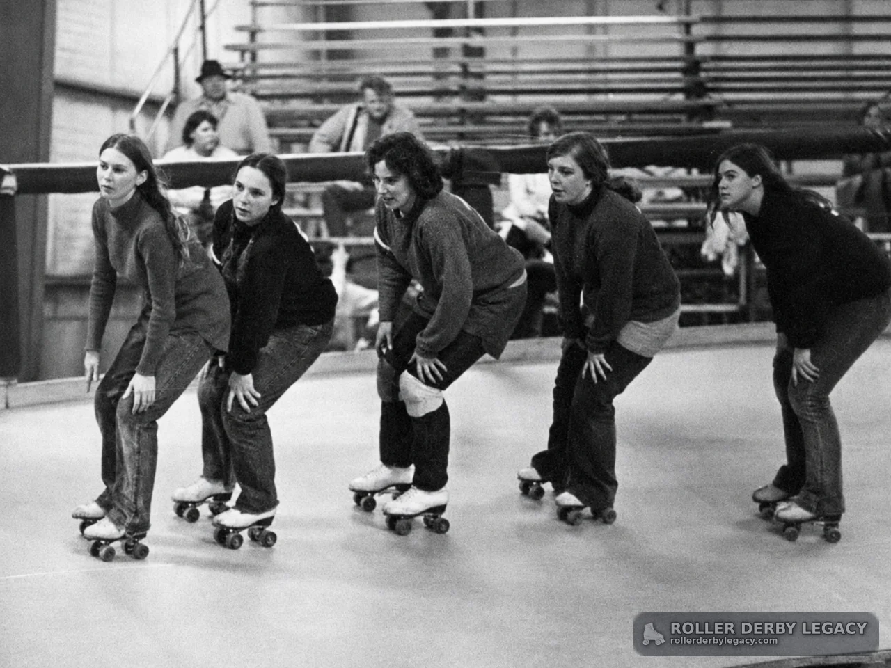 Five Women Skating in an Indoor Rink