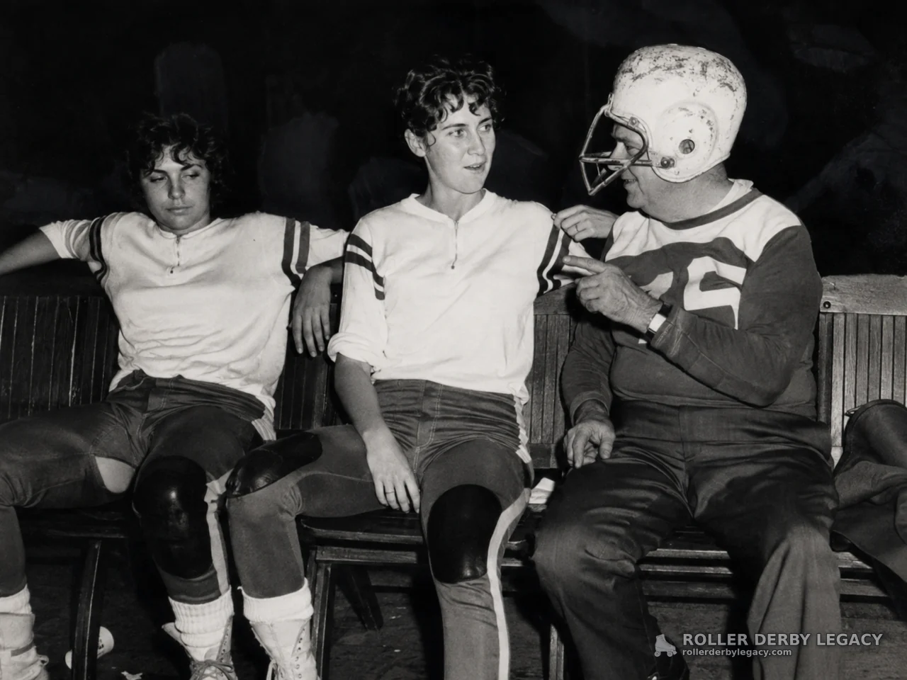 Three Roller Derby Athletes Seated on a Bench