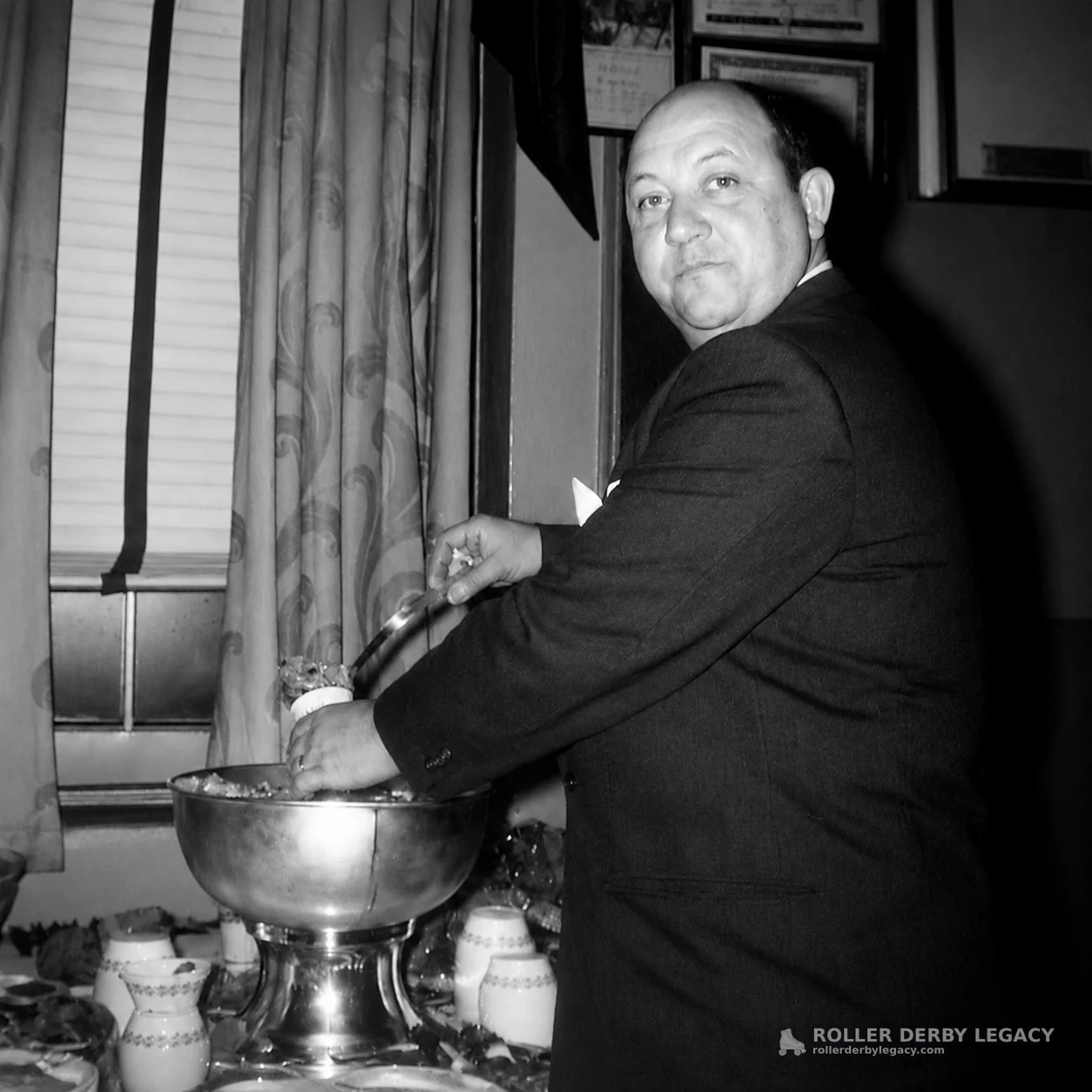 Man Serving from a Metal Bowl Indoors