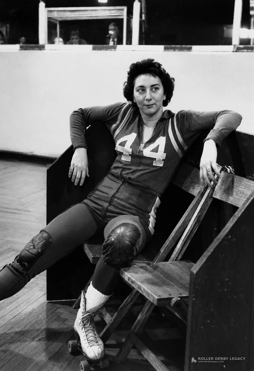 Skater Number 44 Resting on an Indoor Rink Bench