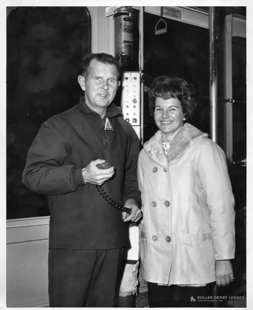 Two People Posing Inside a Vehicle Interior