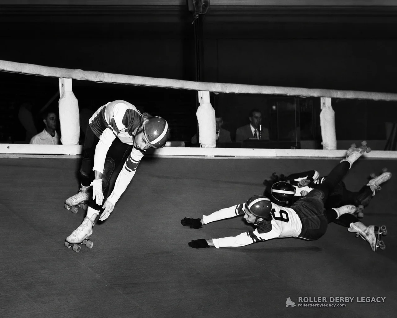 Roller Skaters Tangle on an Indoor Track