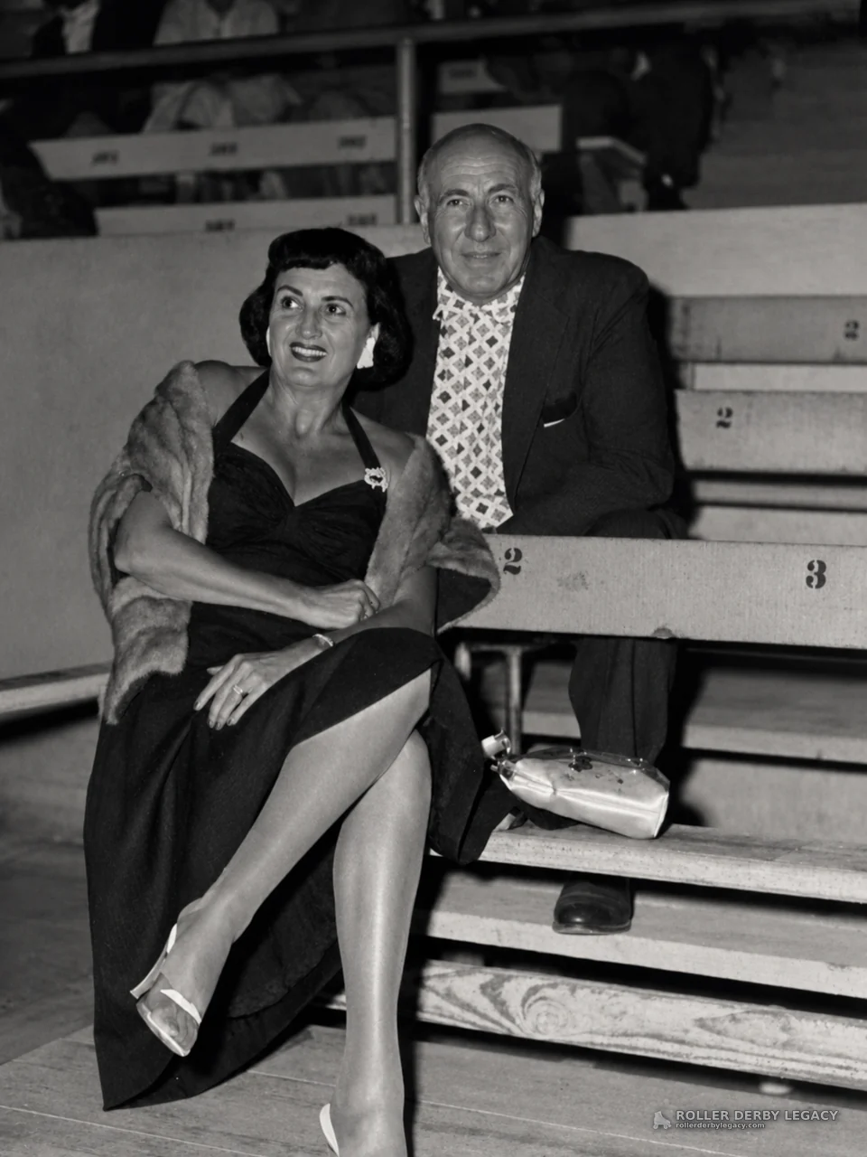 Dressed Spectators on Numbered Arena Bleachers