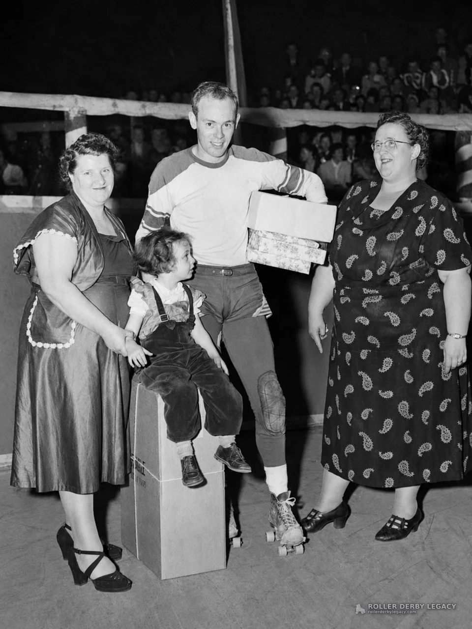 Roller Skater Poses with Family and Boxes in Arena