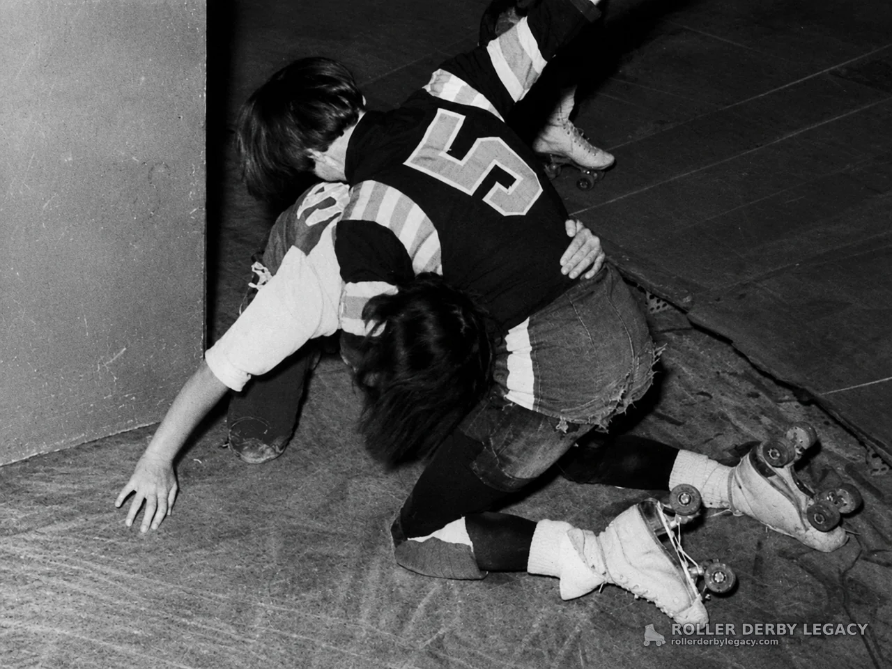 Roller Skaters Fall Near Rink Wall