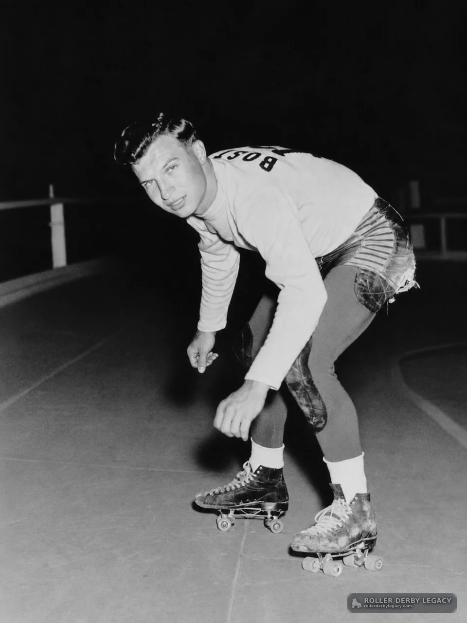 Crouching Roller Skater in an Indoor Rink