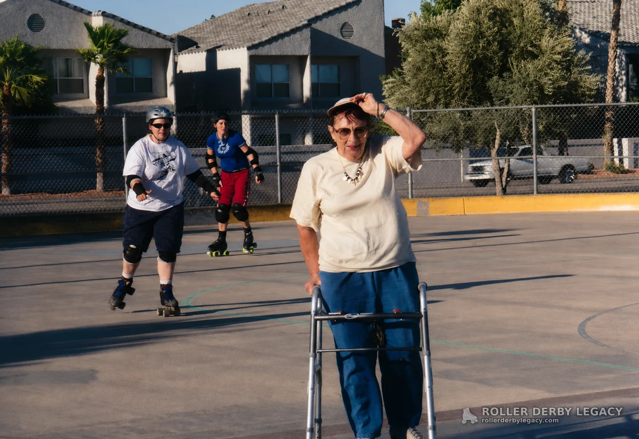 Skaters Behind a Walker User on an Outdoor Court