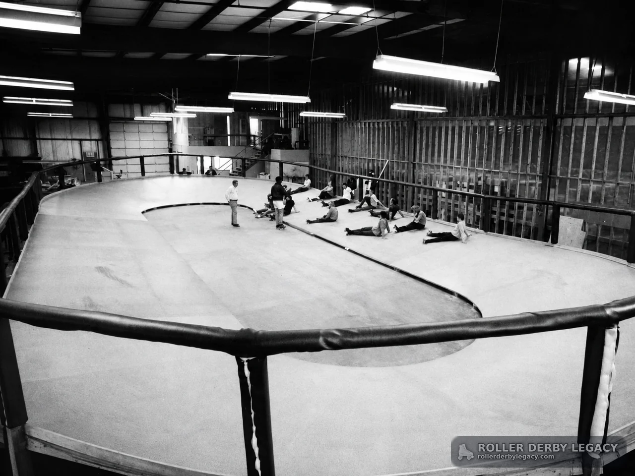 Skaters Stretching on an Indoor Banked Track
