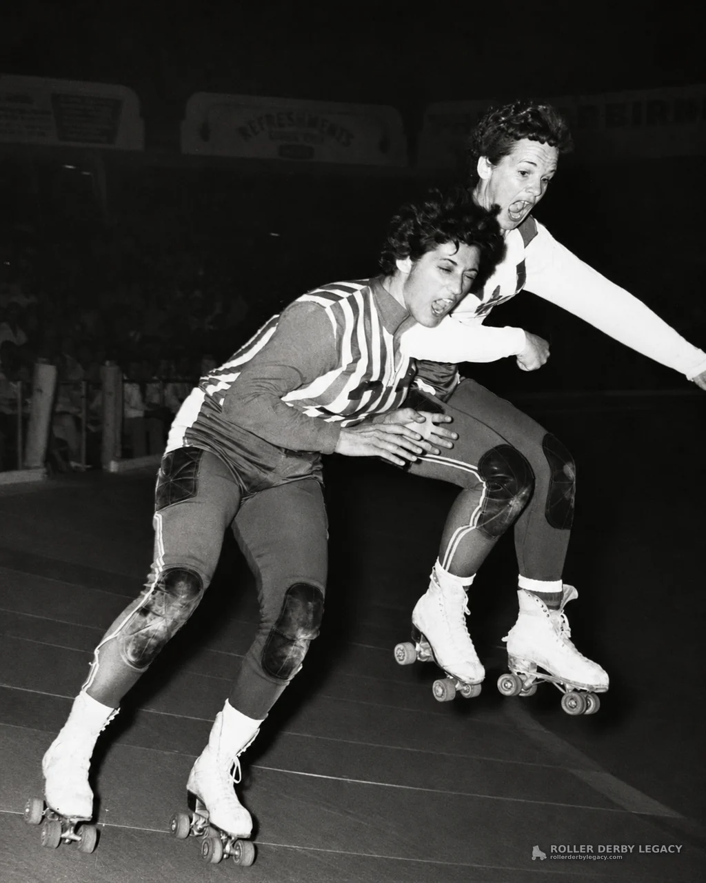 Indoor Roller Derby Skaters Jostling on the Track