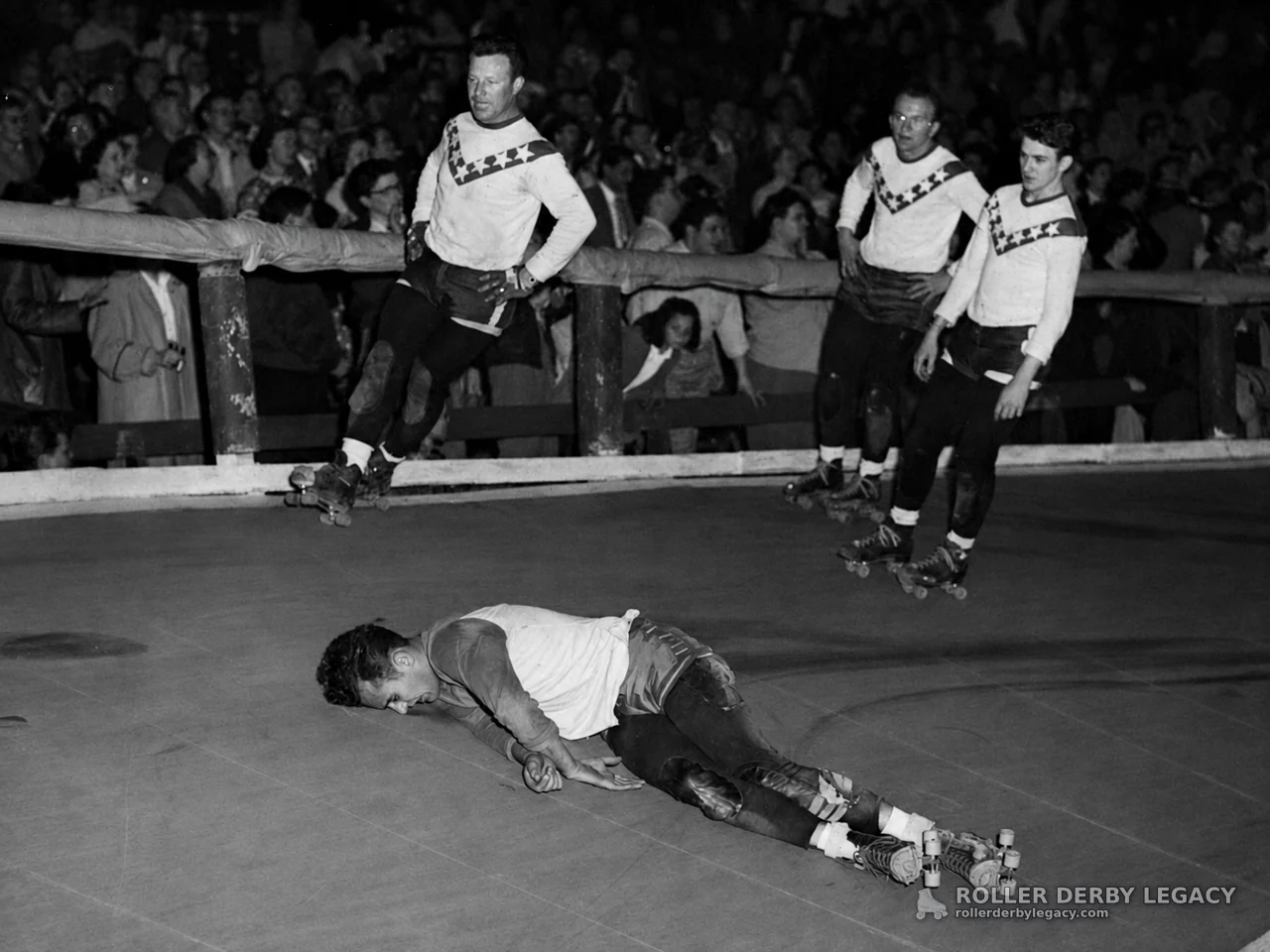 Roller Derby Skater Down as Teammates Pass