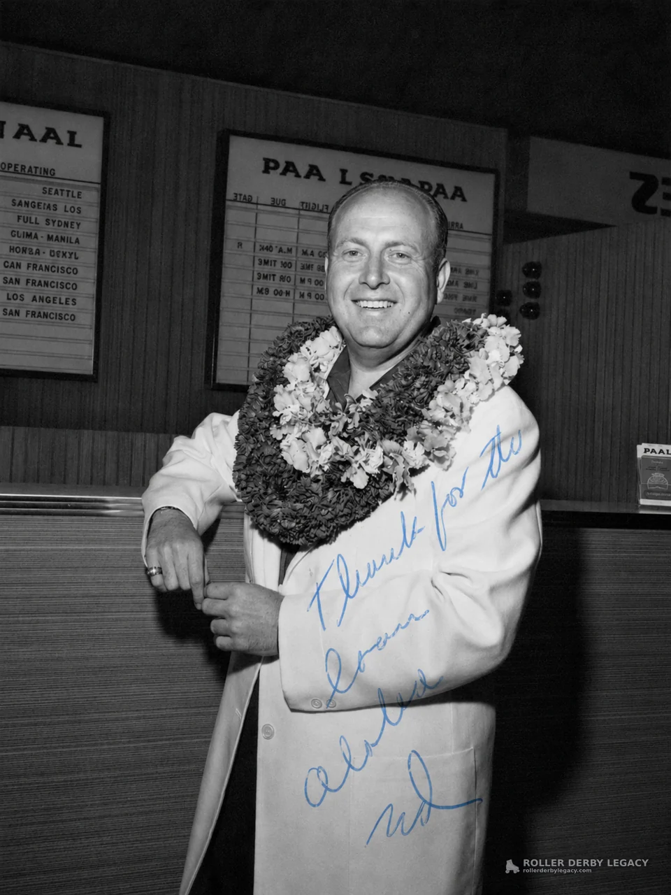 Smiling Man in Leis at Airline Information Counter