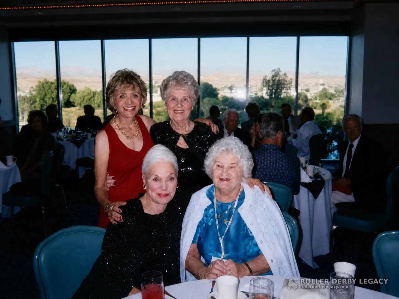 Four Women Posing at a Banquet Table