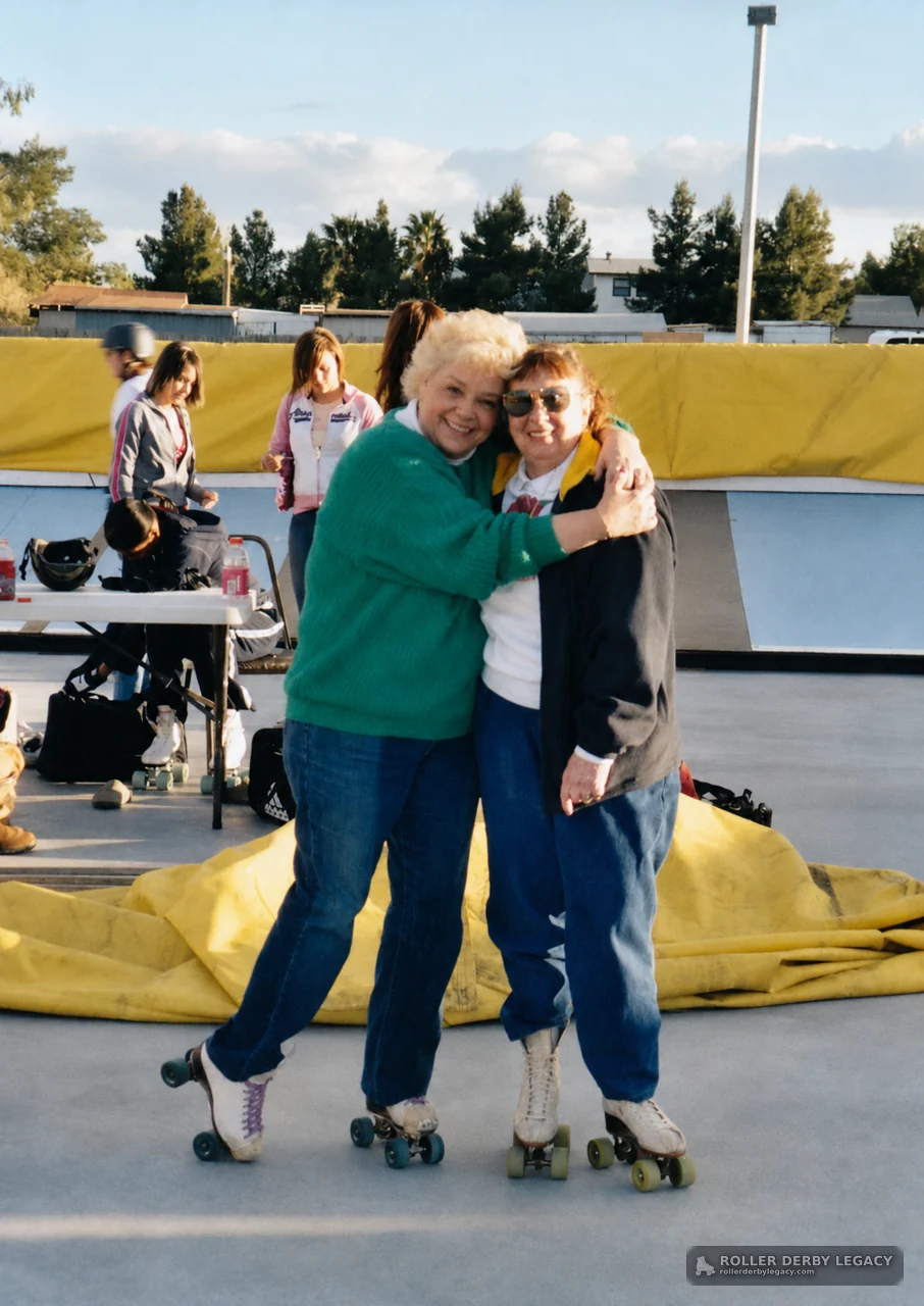 Two Skaters Embracing at an Outdoor Track