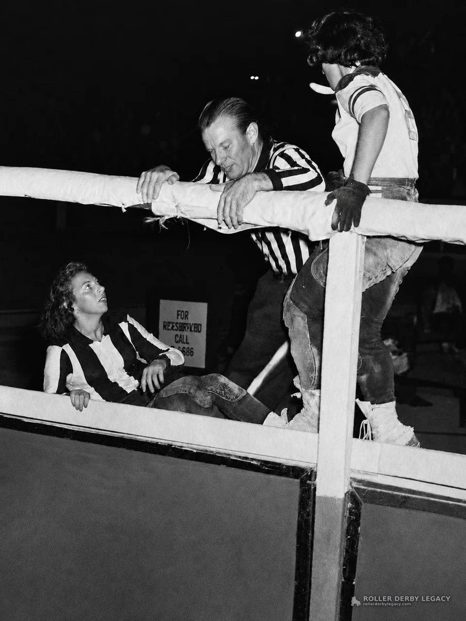 Official at Rink Rail with Two Roller Derby Skaters