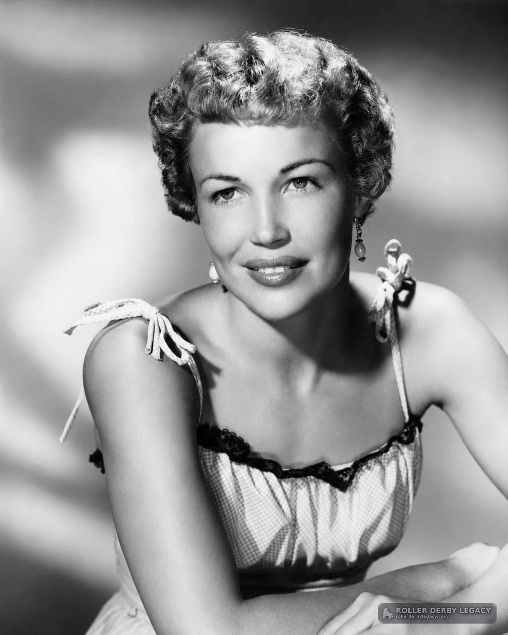 Black-and-White Studio Portrait of Woman in Tied-Strap Dress