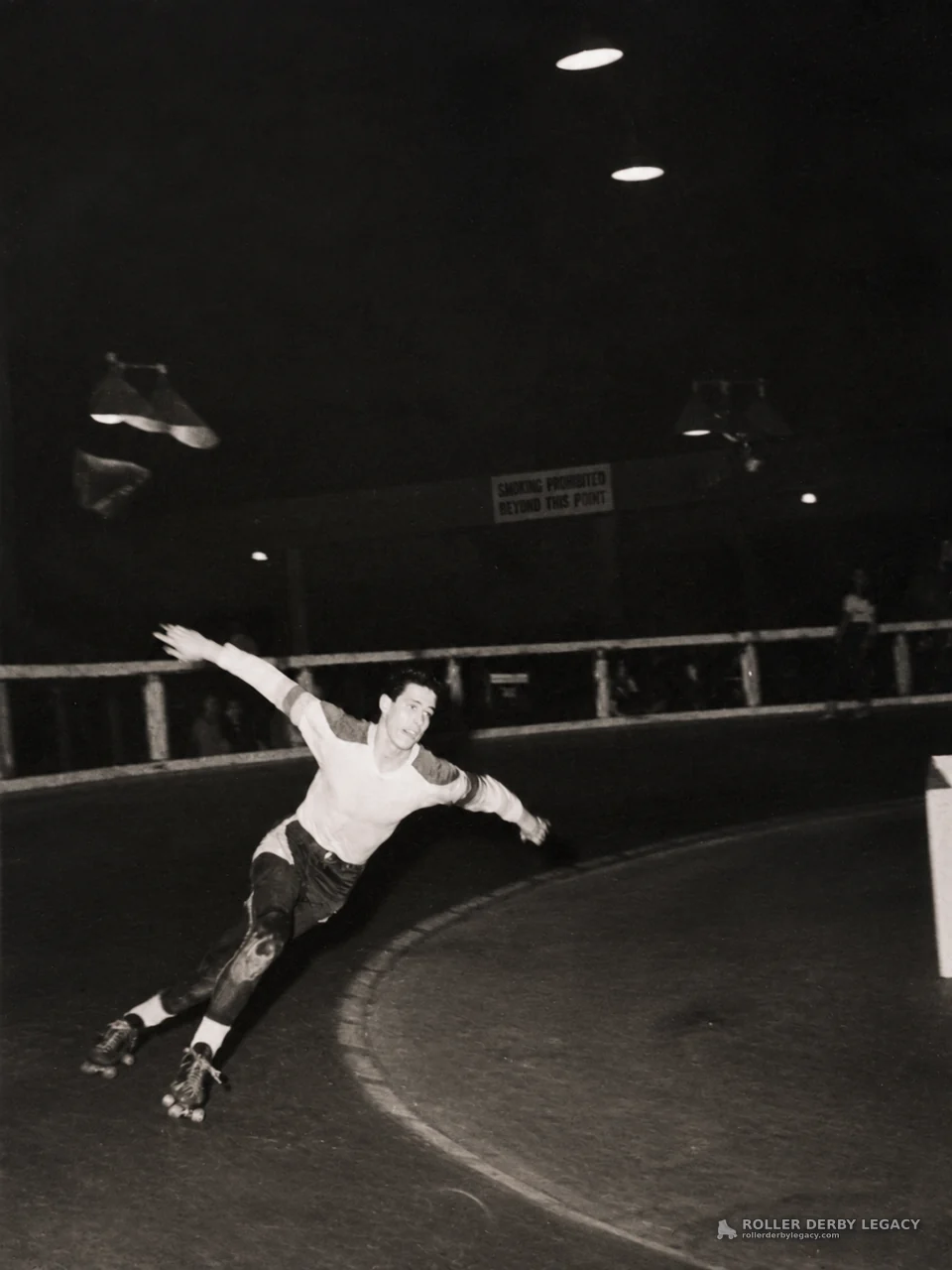 Skater Leaning Into an Indoor Track Turn