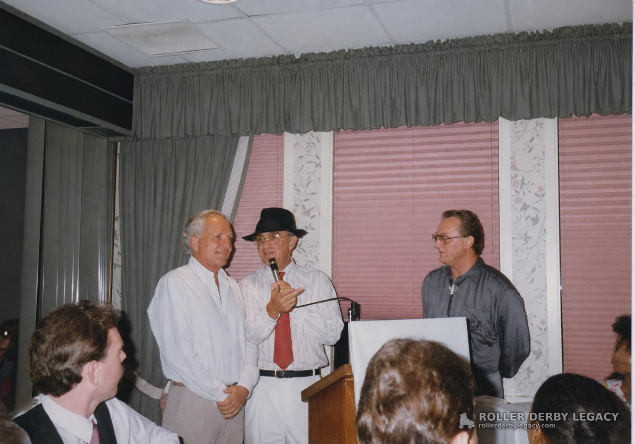 Speaker with Microphone Beside Banquet Room Lectern