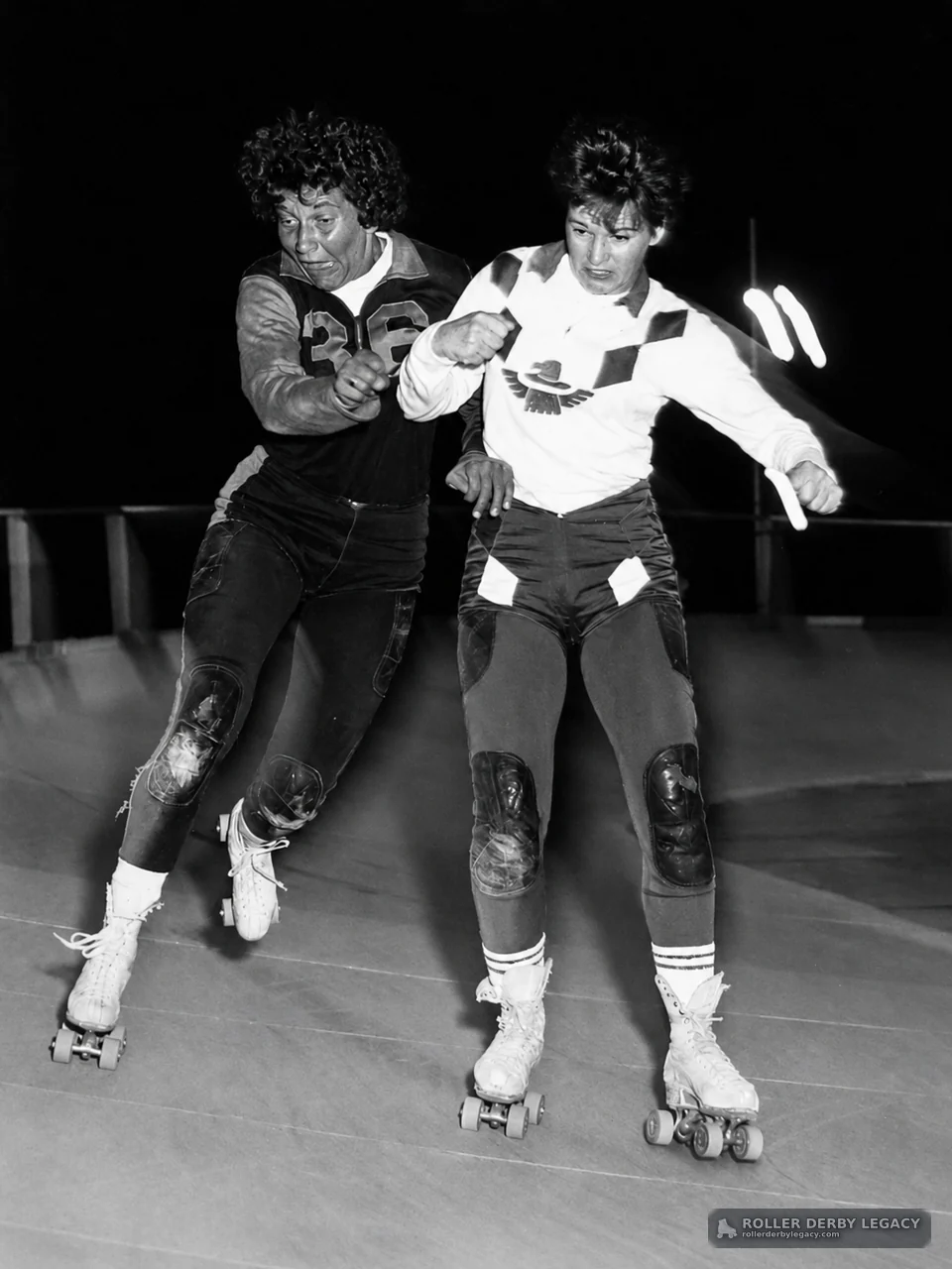 Two Roller Derby Skaters Racing Side by Side
