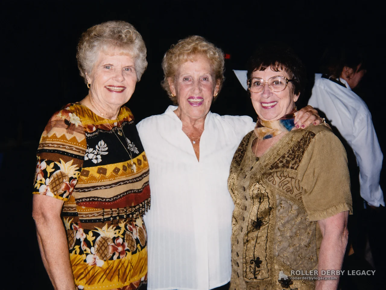 Three Women Smiling at an Indoor Event
