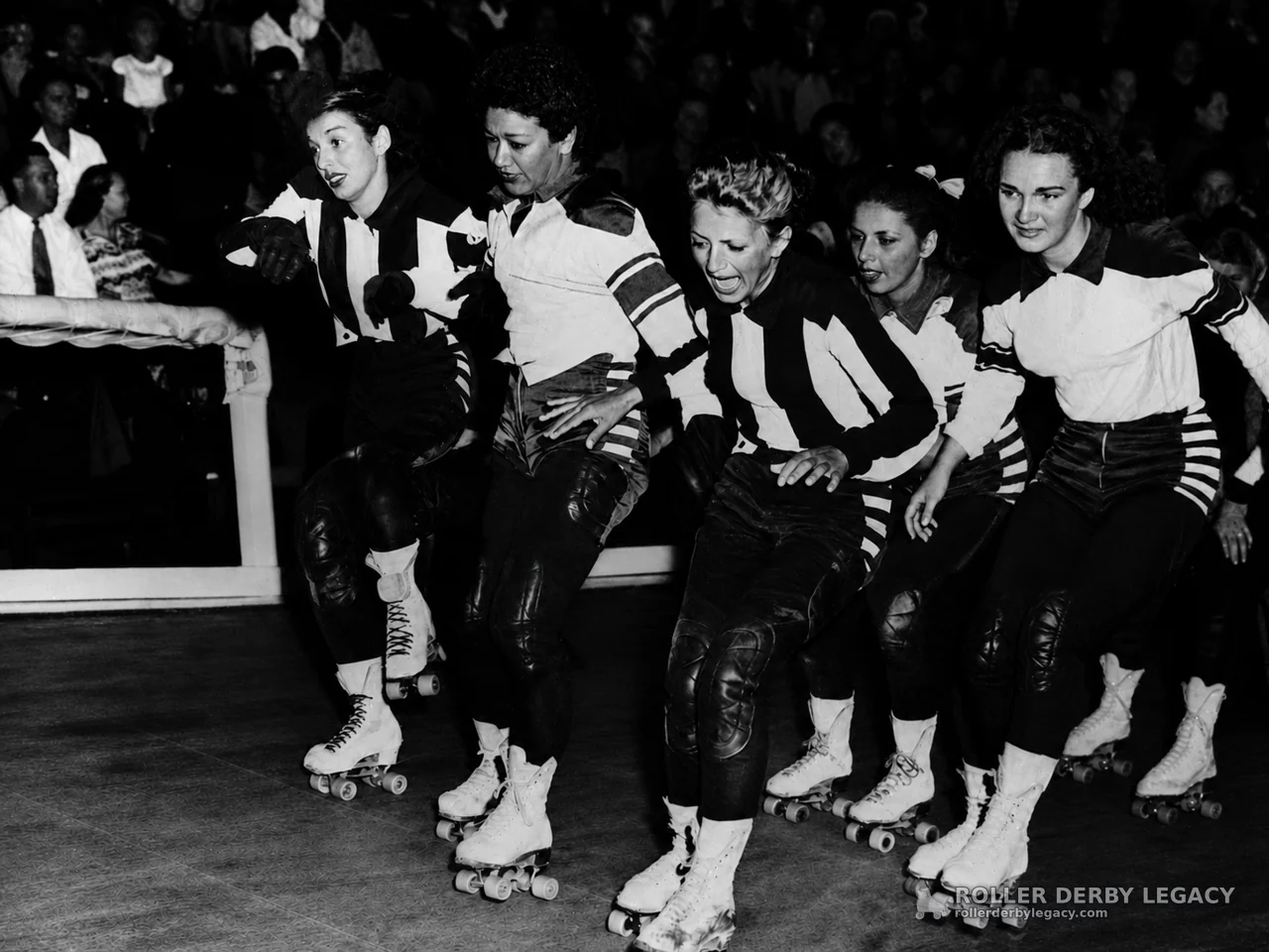 Five Roller Derby Skaters in a Tight Pack