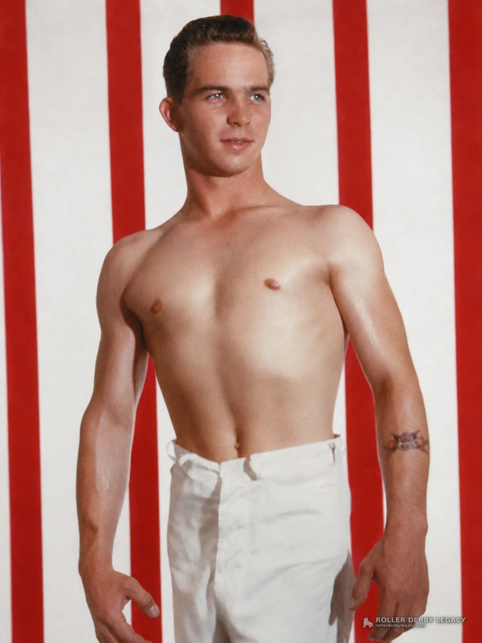 Shirtless Man Before Red-and-White Striped Backdrop