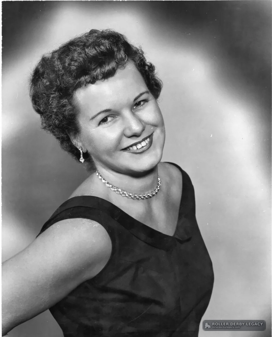 Studio Portrait of Smiling Woman in Dark Dress