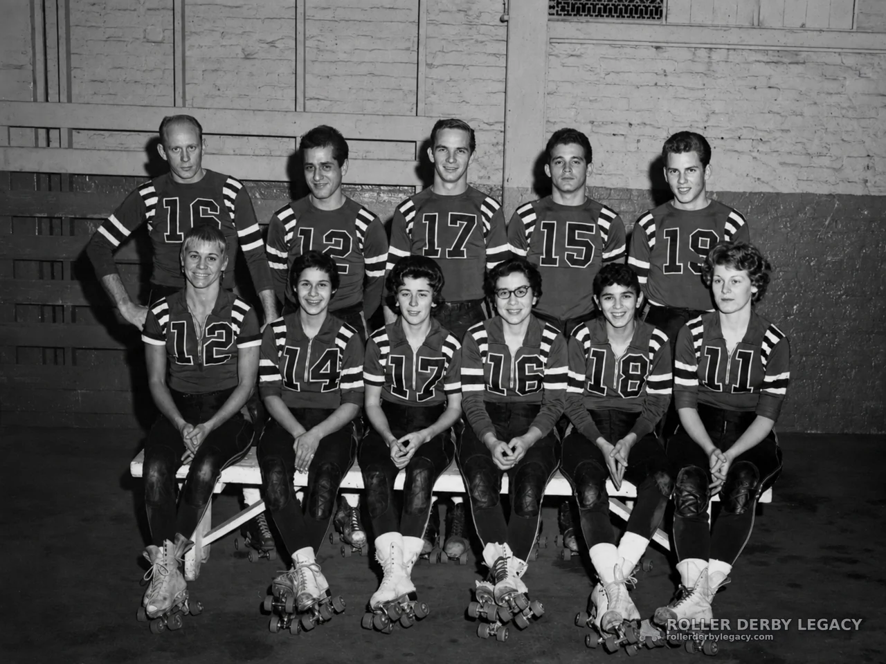 Eleven Numbered Roller Skaters Posed Indoors