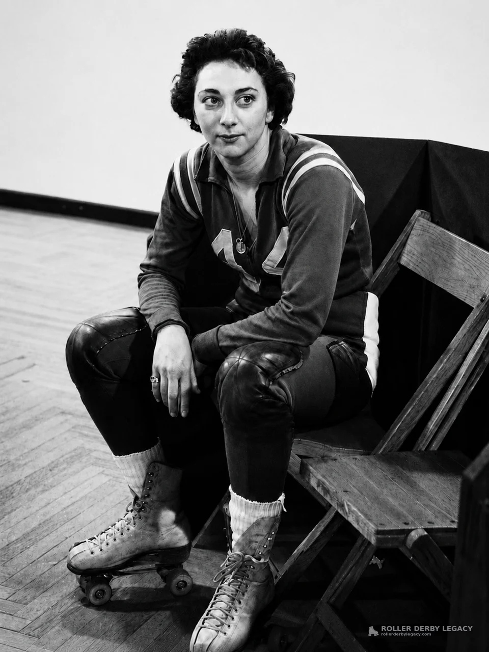Seated Roller Skater in Number 14 Uniform