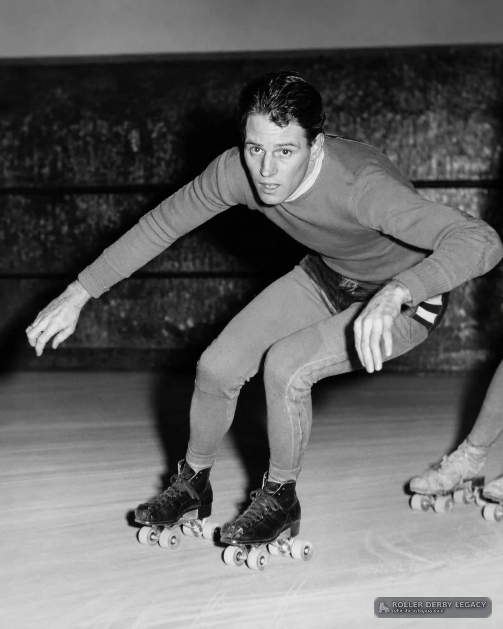 Crouching Skater on an Indoor Rink