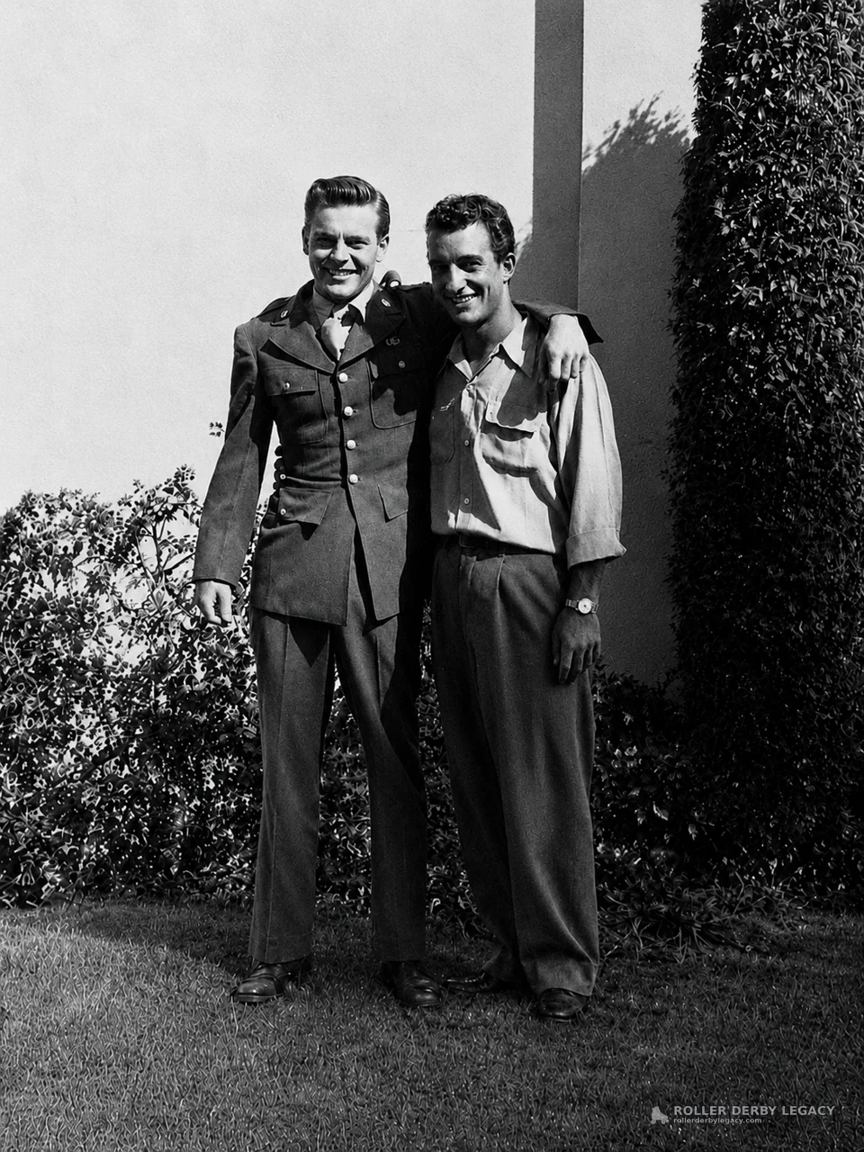 Two Men Standing Arm in Arm Outdoors