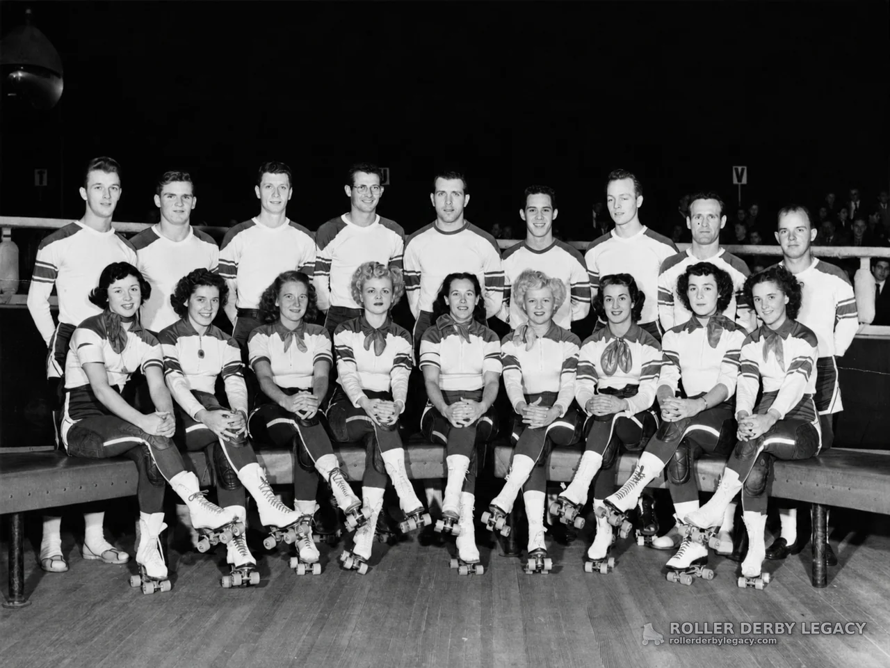 Uniformed Roller Skaters Posed at an Indoor Rink