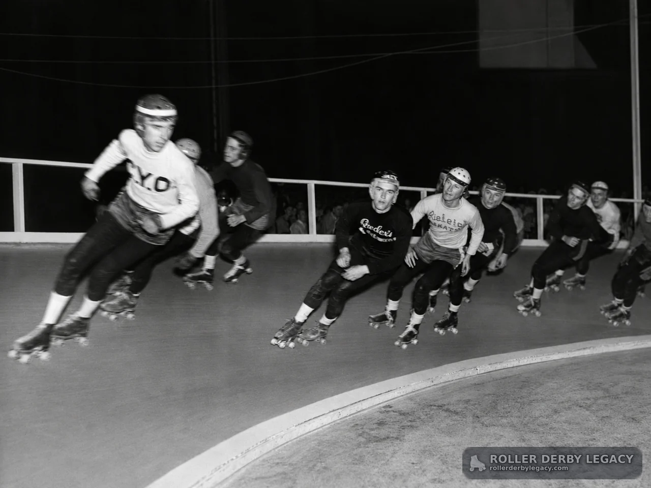 Helmeted Skaters Rounding a Curved Track