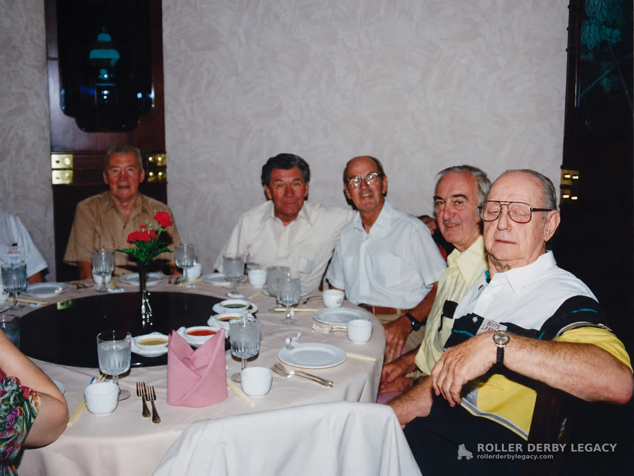 Group Seated Around a Restaurant Dining Table