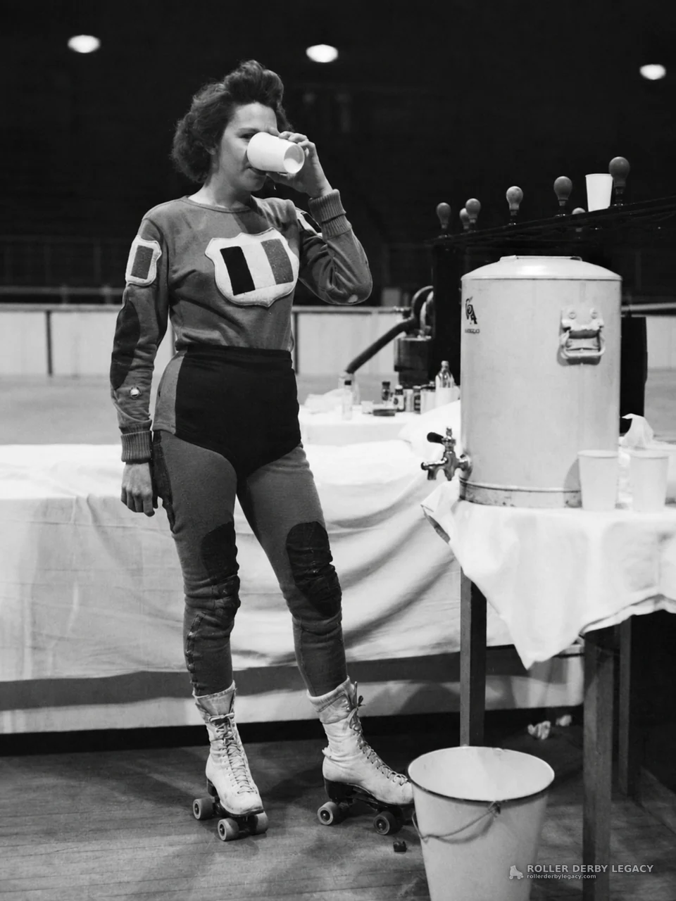 Roller skater drinking beside a beverage cooler