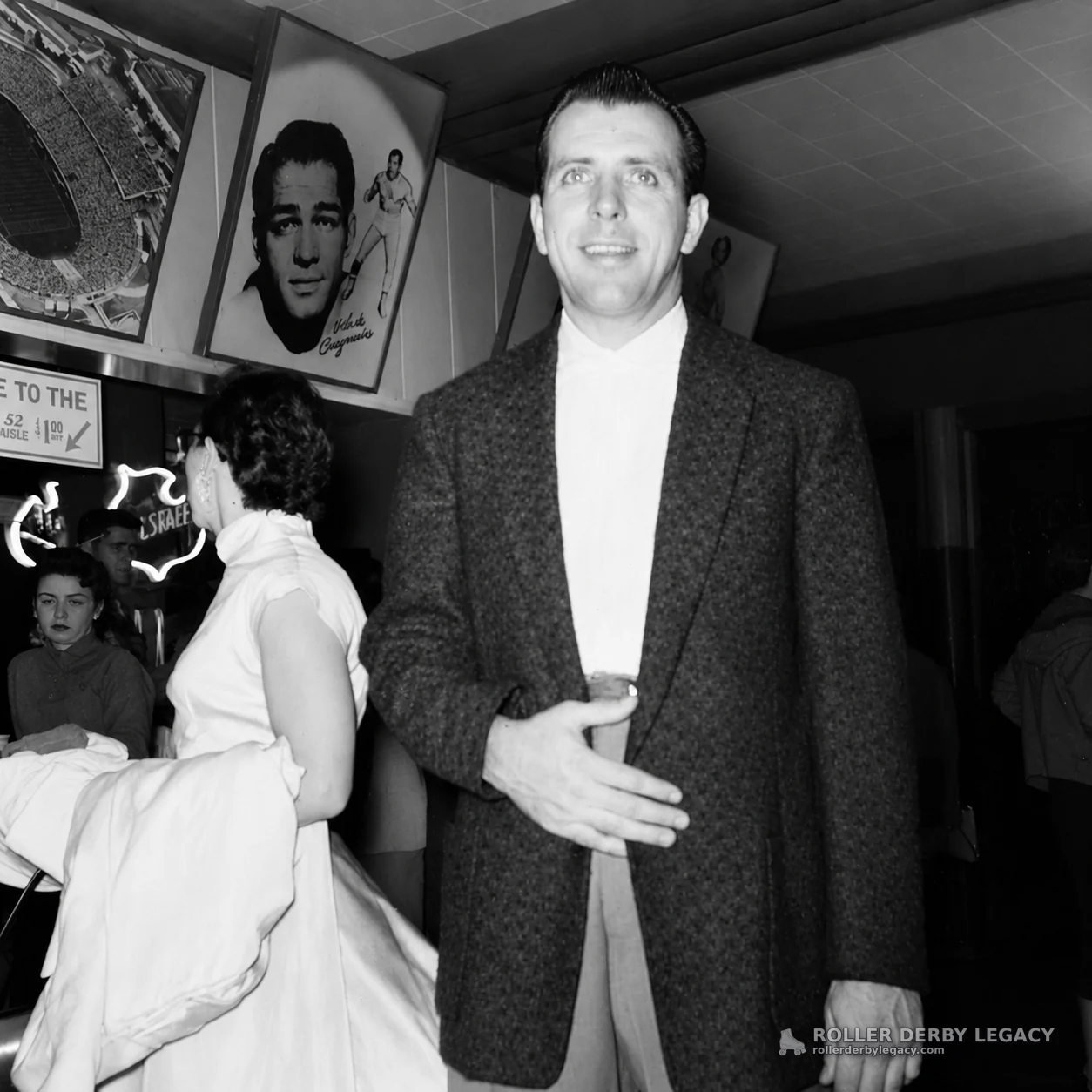 Unidentified Man in Lobby with Sports Posters