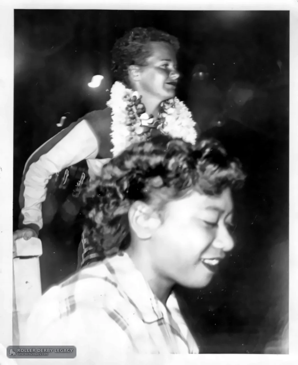 Two Smiling People with Garlands