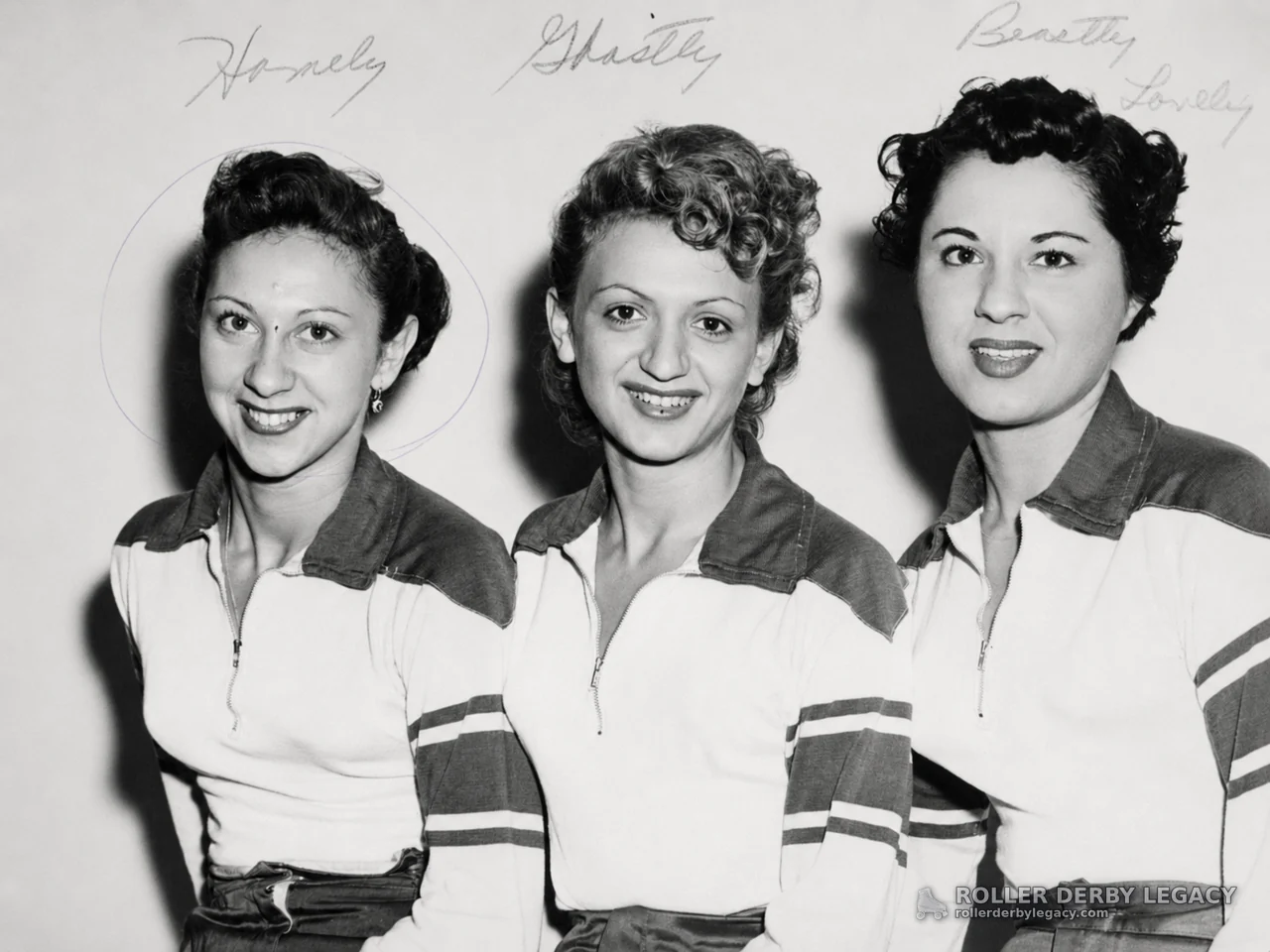 Three Women in Matching Zip-Front Shirts with Handwritten Labels