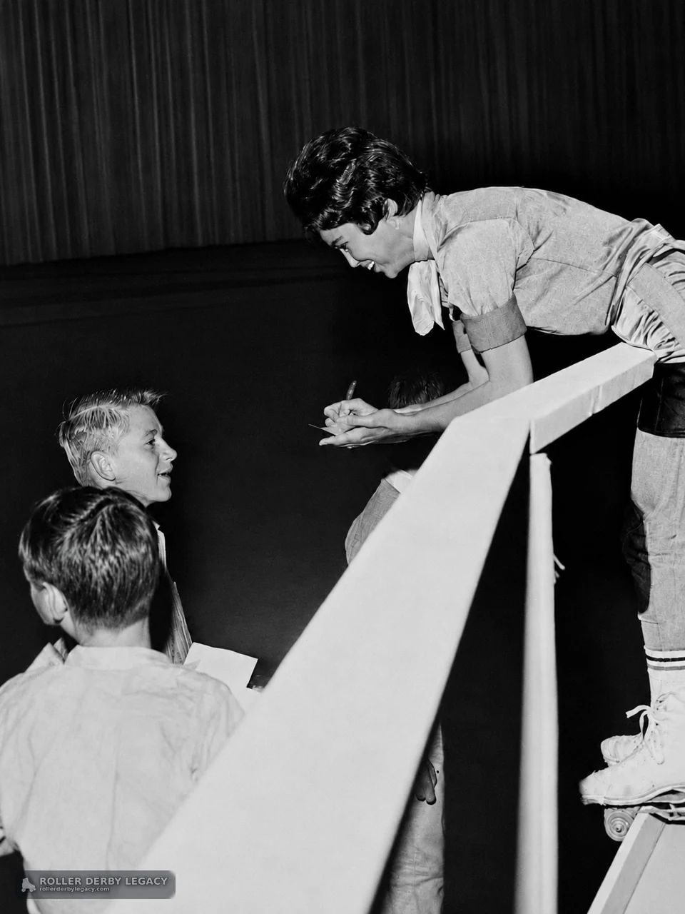 Unidentified Skater Writes for Children at Arena Railing